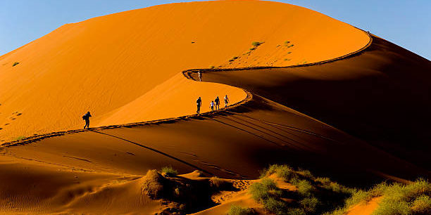 Tourists climbing Sossusvlei dune, Naukluft National Park, Namibia